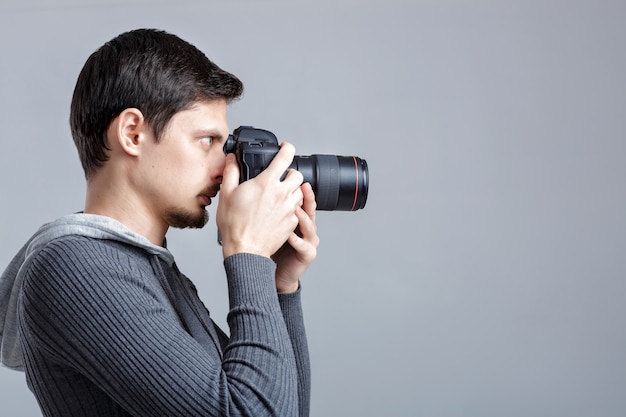 Profile portrait of successful professional photographer use DSL