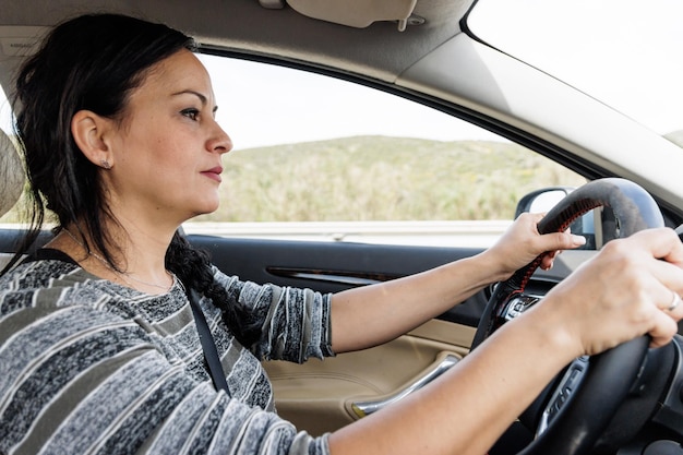 Profile portrait of a woman driving