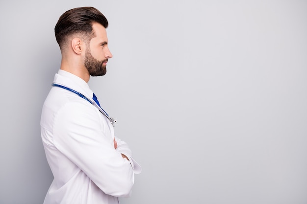 Profile side view portrait of his he nice attractive virile masculine content bearded guy skilled specialist assistant folded arms copy space isolated on light white gray pastel color