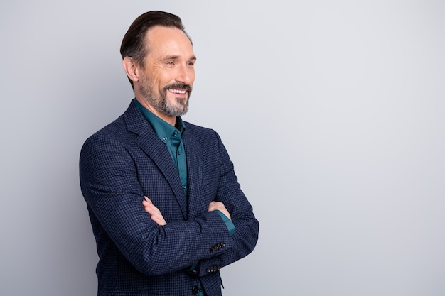 Profile side view portrait of middle age man in suit crossed arms