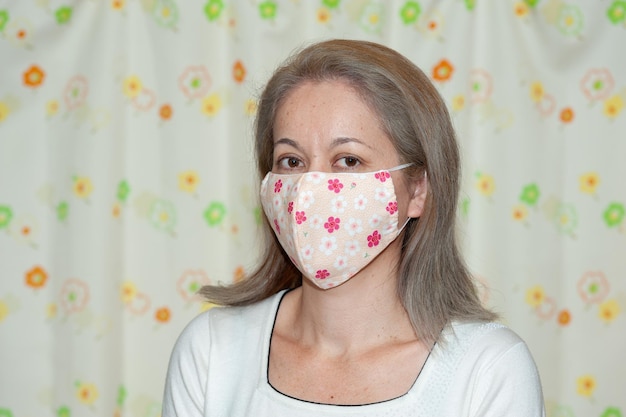 Profile side view portrait of middle aged mixed race woman wearing DIY fabric face mask