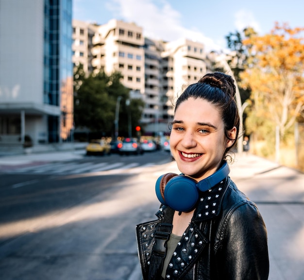 Profile of smiling young woman in a city street