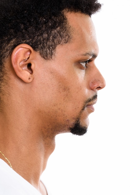 Profile view of face of young African man isolated on white