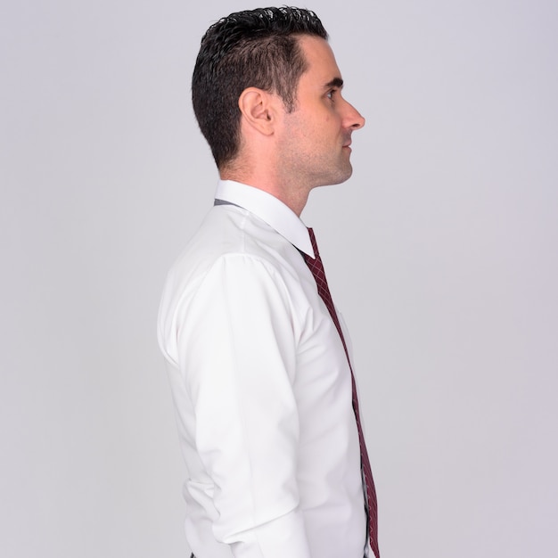 Profile view of handsome businessman on white