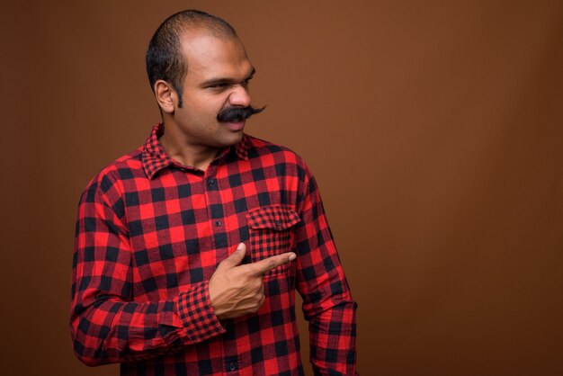 Profile view of Indian hipster man with mustache