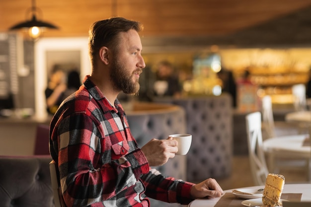 profile view male holding a coffee cup in cafe lifestyle of adult businessman in weekend activity relaxing coffee drinking concept