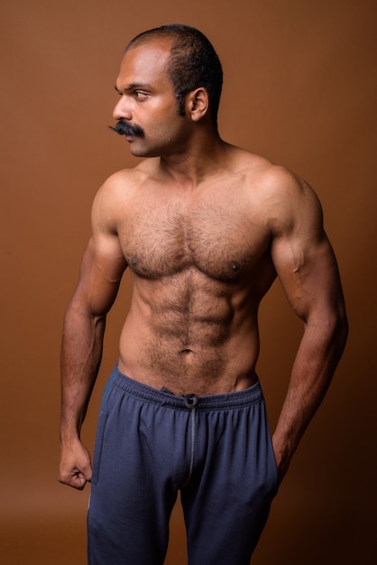 Photo profile view of muscular indian man with mustache shirtless