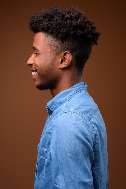 Profile view portrait of young handsome African man smiling