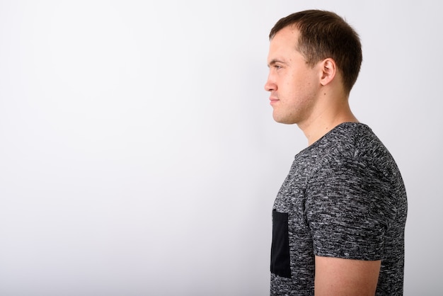 Profile view portrait of young muscular man standing