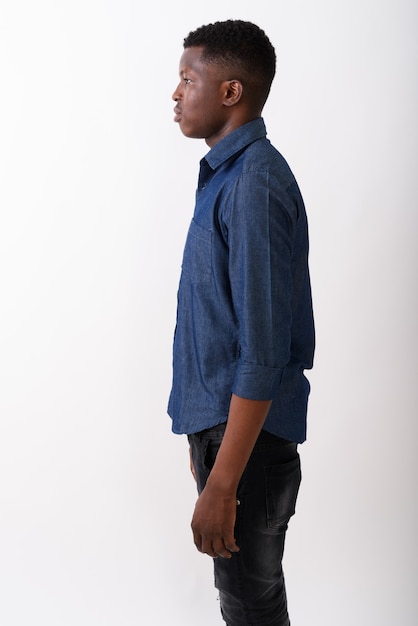 Profile view of young black African man standing