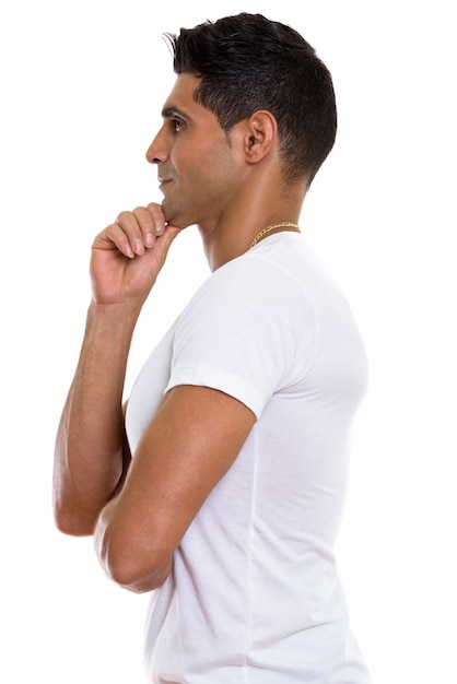 Profile view of young muscular Persian man thinking