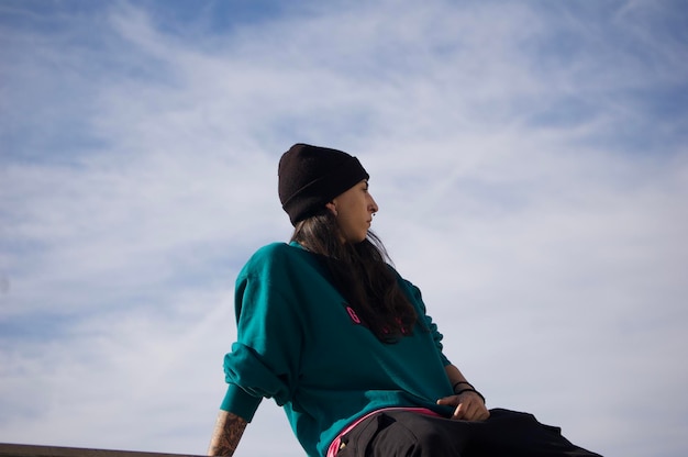 Profile view of young woman with a hat during day