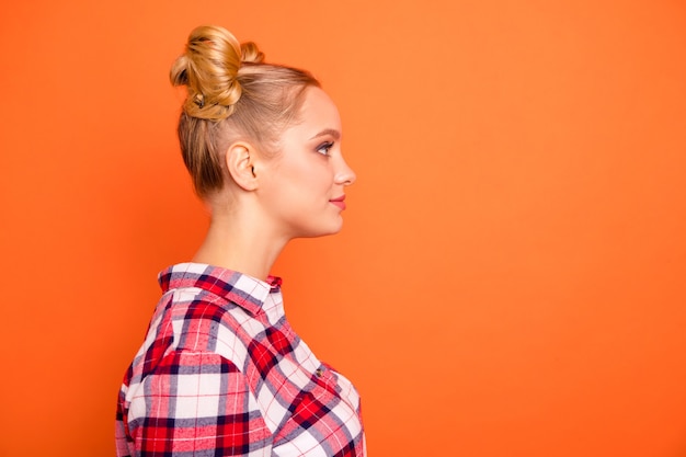 Photo profile young woman dressed in a plaid checked shirt isolated on orange