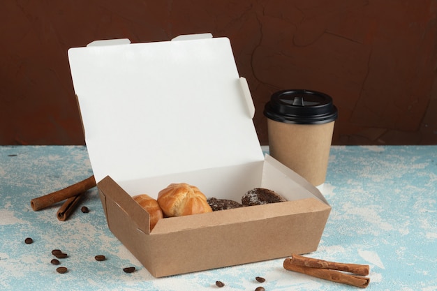 Profiteroles with cream in craft packaging