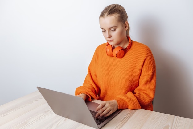 A programmer girl works at a laptop