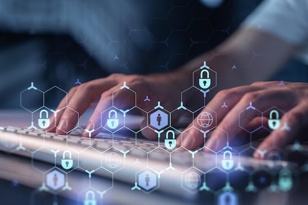 a programmer is typing a code on a keyboard to protect a cyber security from hacker attacks and save clients confidential data padlock hologram icons over the typing hands