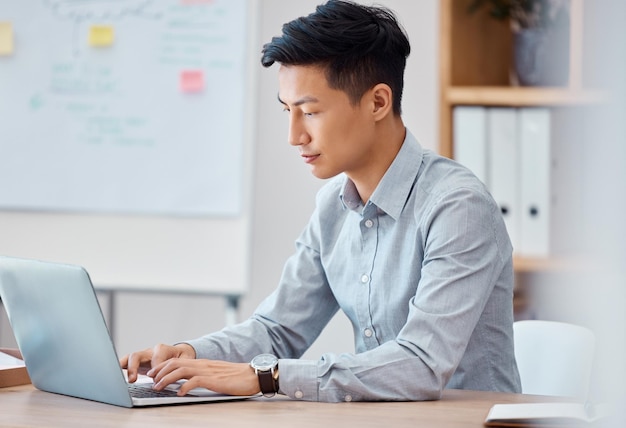 Programmer laptop and software engineer working coding and typing up cyber security data on the internet Digital web design and young Asian businessman busy with an email message in an office