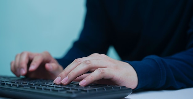 programmer typing on keyboard at computer desktop for input coding language to software in operation room