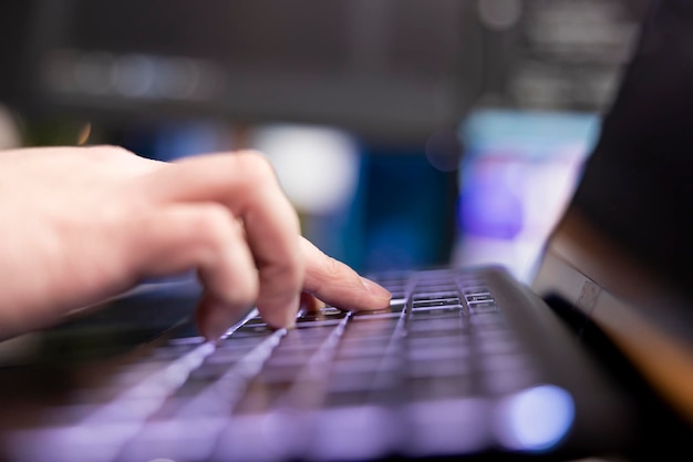 Programmer typing on keyboard designing software extreme close up