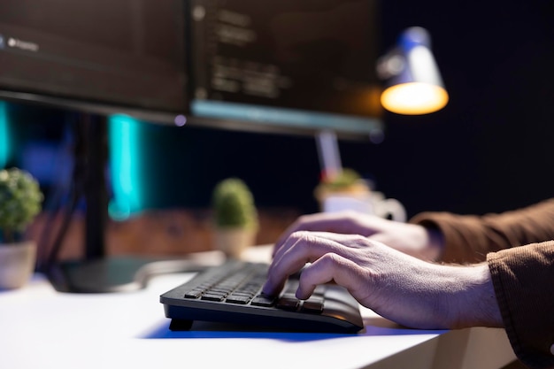 programmer typing on keyboard testing and debugging code close up