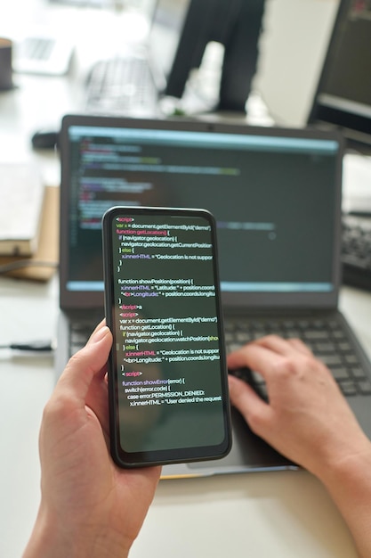 programmer using smartphone to install software program