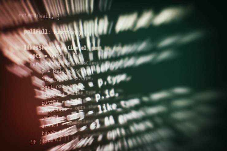 Photo programmer working in a software develop company office. digital binary data on computer screen. computer script typing work. programming code abstract screen of software developer.