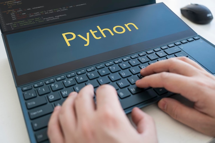 Photo programmer writes a program in python male hands on a black keyboard
