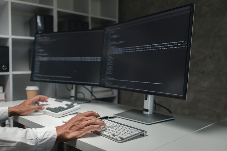 Photo programmers write programs on the computer designing programs to meet the needs of users and friendly users designing programs to help manage various operations easily programmer concept