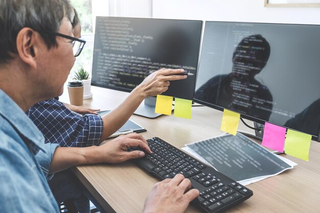 Foto programmeurs die op kantoor computers gebruiken