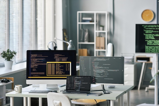 Programming code on multiple screens in office of it\
company