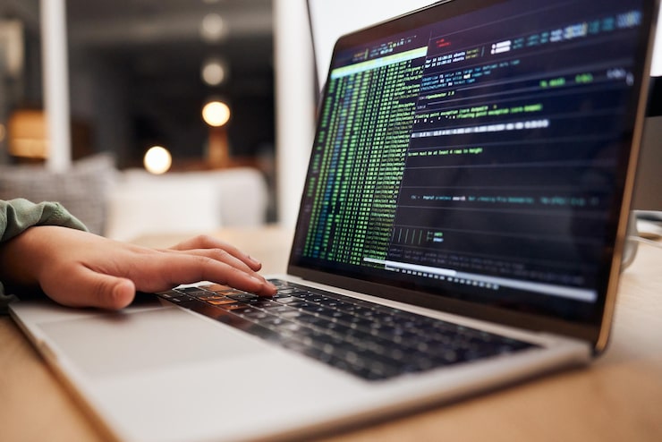 Photo programming coding and hands typing on laptop for website hacking and cybersecurity in office information technology software and person on computer for big data network update and web design