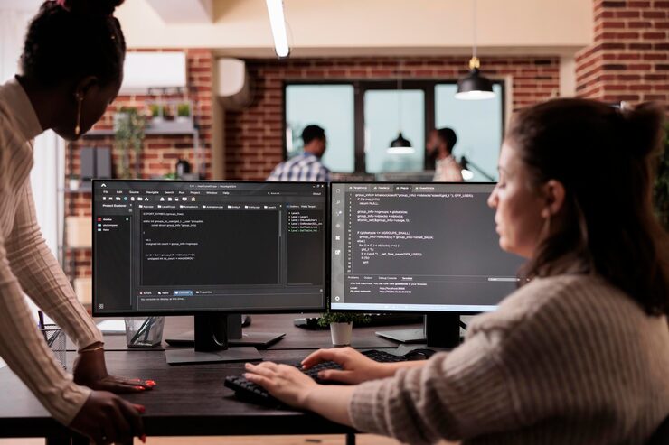 Photo programming engineers using computer to write code and develop algorithm program. software developers working on user interface with html script and terminal window in development company.