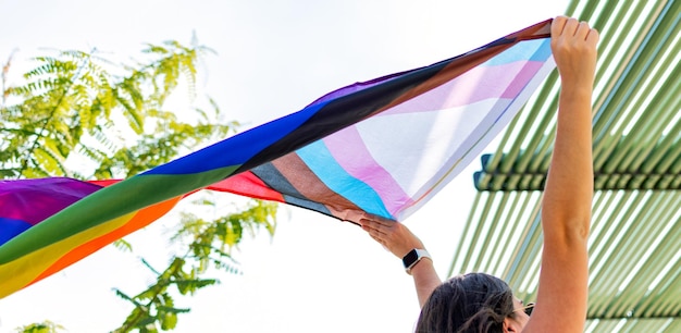 Progress pride flag Lesbian woman with gay pride flag on the street