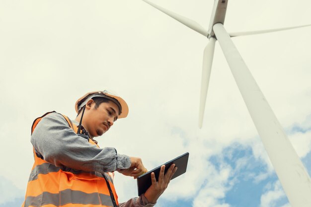 Progressive concept of engineer working in the wind farm atop of the mountain