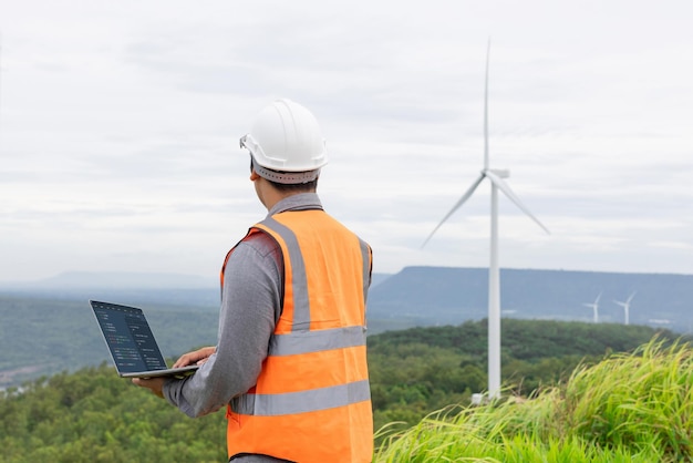 Progressive concept of engineer working in the wind farm atop of the mountain