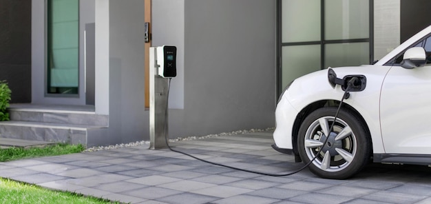 Photo progressive concept of ev car and home charging station in residential area