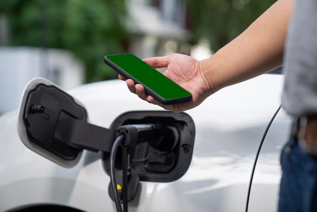 Progressive concept of green screen mockup phone EV car and charging station