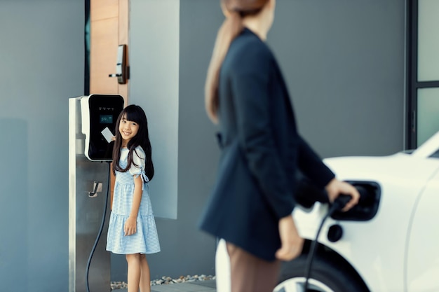 Progressive lifestyle of mother and daughter with EV car and charging station