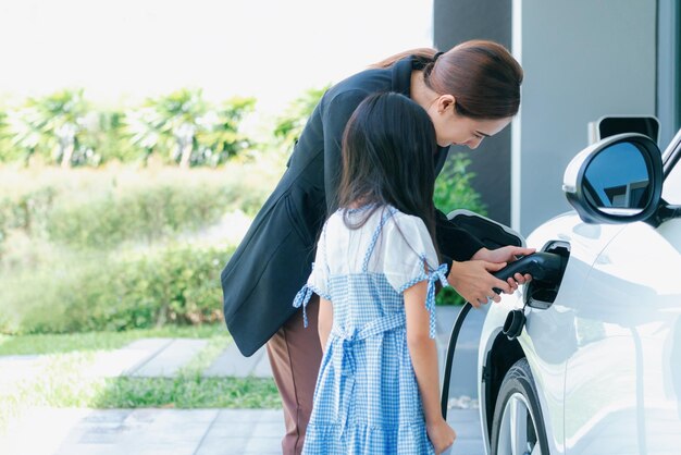 Progressive lifestyle of mother and daughter with EV car and charging station