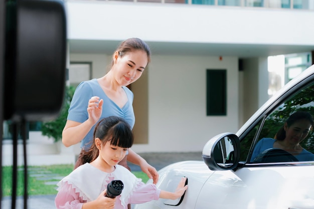 Progressive lifestyle of mother and daughter with EV car and charging station