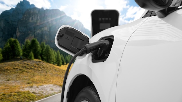 Progressive travel concept by EV car in remote mountain with charging station