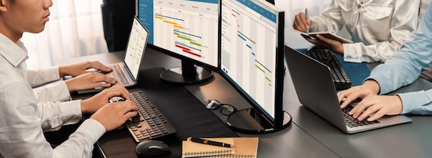 Project management team coordinating and update project planned schedule on computer using Gantt chart software in office Business people planning time and deadline for company task Trailblazing