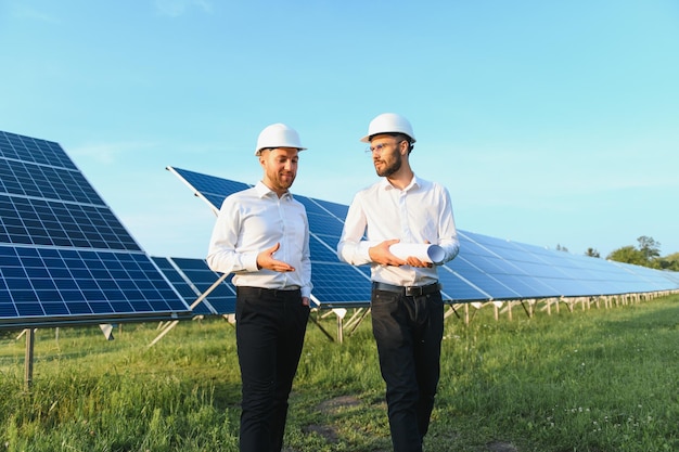 Project manager discuss with worker installation process of solar panel