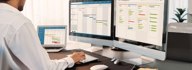 Project manager planning schedules for business task on office using gantt chart software display on screen Modern business management and work flow organization Trailblazing