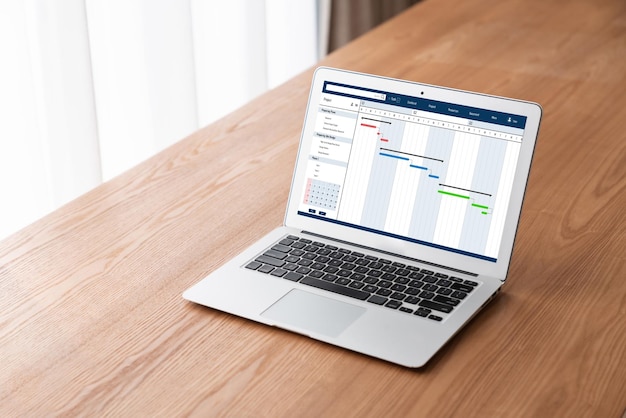 Project planning software for modish business project management on the computer screen showing timeline chart of the team project