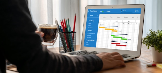 Project planning software for modish business project management on the computer screen showing timeline chart of the team project