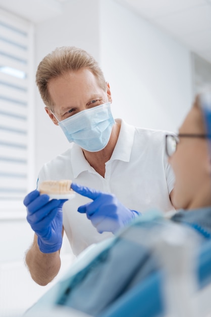 Prominent trained friendly doctor making sure his patient understanding the procedure she undergoing and not being afraid