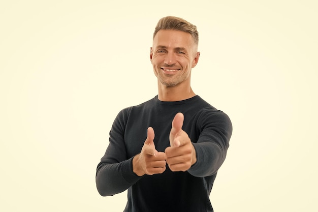 Promote your product happy man advertising product handsome guy pointing fingers isolated on white presenting product product promotion promoting and marketing sale and discount copy space