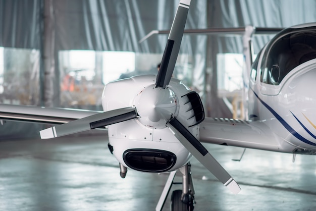 Propeller airplane in hangar, plane on inspection