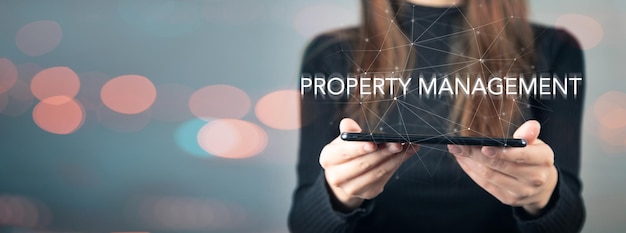 Property management and phone in woman's hand